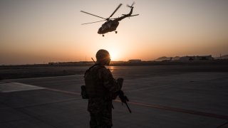 U.S. soldier watches a helicopter in Afghanistan