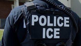In this June 19, 2018, file photo, U.S. Immigration and Customs Enforcement's (ICE) special agent prepares to arrest alleged immigration violators at Fresh Mark, Salem. Image courtesy ICE ICE / U.S. Immigration and Customs Enforcement.