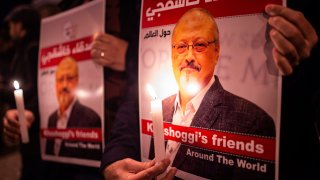 In this file photo, people hold posters picturing Saudi journalist Jamal Khashoggi and lightened candles during a gathering outside the Saudi Arabia consulate in Istanbul, on October 25, 2018.
