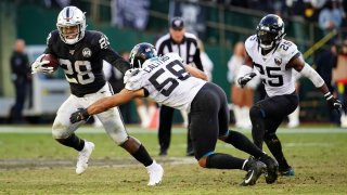 Josh Jacobs of the Oakland Raiders is tackled on a run.