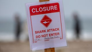 A shark attack sign is posted at the Sand Dollar Beach section of Manresa State Beach in Watsonville.