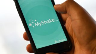 A person checks the "MyShake" app on their smartphone.