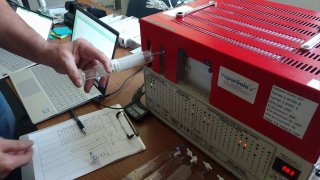 A machine tests air samples for contamination at an Oakland high school.