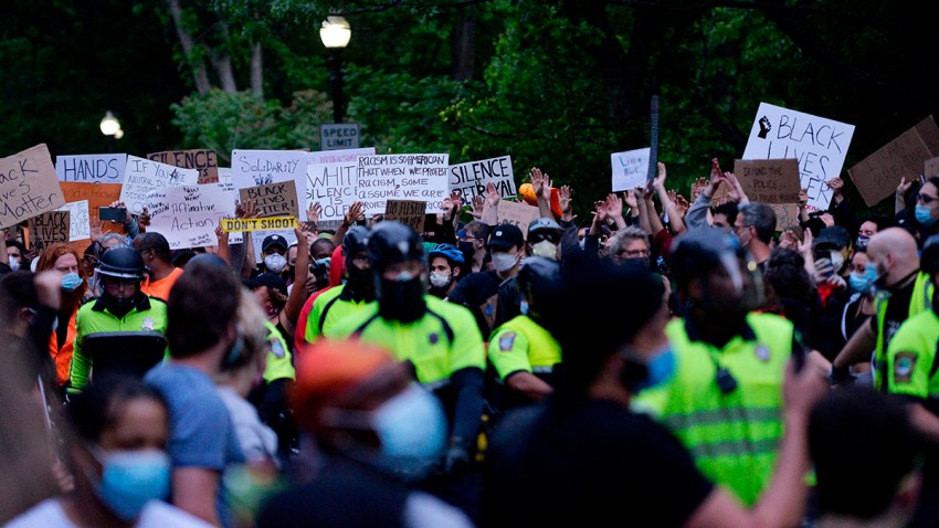 Protesters and police officers are seen at a peaceful demonstration in protest of the death of George Floyd and other black lives lost to police across the U.S. at Franklin Park in Boston, Massachusetts, June 2, 2020.