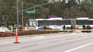 Officials in Redwood City work at the scene of a deadly collision involving a pedestrian and a SamTrans bus.