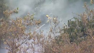 Firefighters battle a brush fire in unincorporated San Jose.