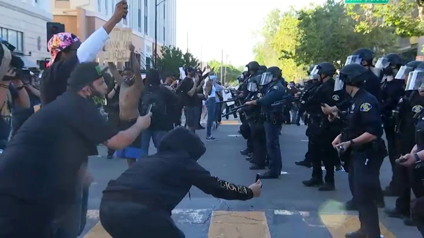 Protesters face off with police in downtown San Jose.