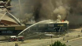 Firefighters battle a blaze at a strip mall in San Jose.