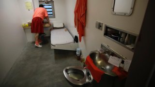 In this photo taken on Monday, Dec. 16, 2019, an inmate looks out a window in his solitary confinement cel at the Main Jail in San Jose, Calif. Several California counties are drastically restricting their use of solitary confinement with policies that experts say could be national models. While some jurisdictions elsewhere are banning isolation for youthful offenders, pregnant women or those with pre-existing mental health diagnoses, the California counties’ broader approach of generally limiting its use to inmates who engage in continued violent behavior has brought dramatic reductions in both the number of inmates in isolation and the length of time they stay there. (AP Photo/Ben Margot)