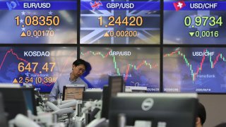 In this April 29, 2020, file photo, a currency trader watches monitors at the foreign exchange dealing room of the KEB Hana Bank headquarters in Seoul, South Korea.