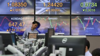 In this April 29, 2020, file photo, a currency trader watches monitors at the foreign exchange dealing room of the KEB Hana Bank headquarters in Seoul, South Korea.