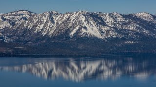 The snowcapped mountains around the lake are viewed from the Heavenly Mountain observation deck.