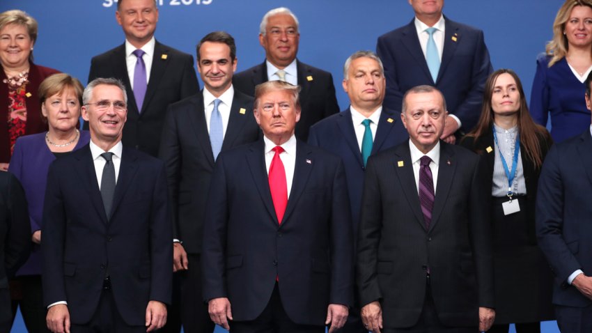 President Donald Trump, center, front, NATO Secretary General Jens Stoltenberg, center left, and Turkish President Recep Tayyip Erdogan, front right, pose with other NATO heads of state for a group photo during a NATO leaders meeting at The Grove hotel and resort in Watford, Hertfordshire, England, Wednesday, Dec. 4, 2019. NATO Secretary-General Jens Stoltenberg rejected Wednesday French criticism that the military alliance is suffering from brain death, and insisted that the organization is adapting to modern challenges.