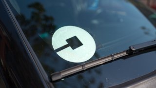 Logo for car-sharing company Uber on the passenger side windshield of a vehicle in the South of Market (SoMa) neighborhood of San Francisco, California, October 13, 2017.