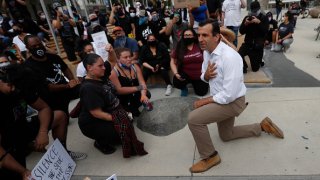 Protesters listen to San Jose Mayor Sam Liccardo as he takes a knee during a protest of the killing of George Floyd outside of San Jose City Hall in downtown San Jose, Calif., on Sunday, May 31, 2020. (Photo by Nhat V. Meyer/MediaNews Group/The Mercury News via Getty Images)