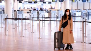 This March 18, 2020, file photo, shows the last passengers at the Brussels Airport in Zaventem, Belgium, before all flights were cancelled.