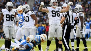 Raiders player Maxx Crosby posing after a sack