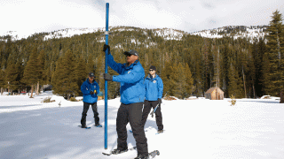 Sean de Guzman, chief of snow surveys for the California Department of Water Resources, center, prepares to plunge the snow survey tube into the snowpack during the second snow survey of the season at Phillips Station near Echo Summit, Calif., Thursday, Jan. 30, 2020. The survey found the snowpack at 40.5 inches deep with a water content of 14.5 inches.
