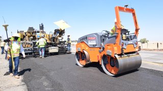 Crews repave a stretch of highway in Northern California with a mixture that includes single-use plastic bottles.