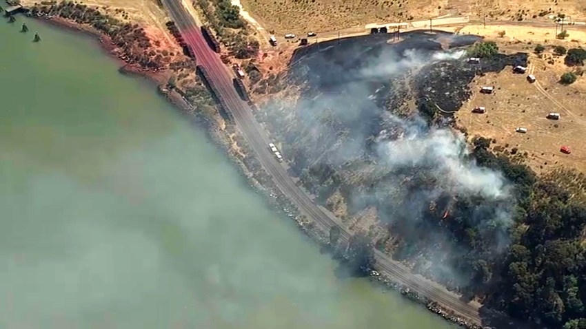 Firefighters battle a brush fire near Crockett.