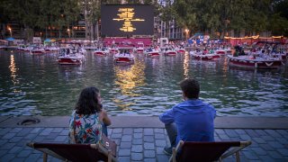 Parisians watch a floating cinema