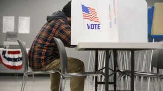 person in voting booth