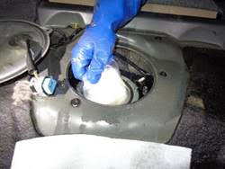 A gloved hand holds a bag of methamphetamine