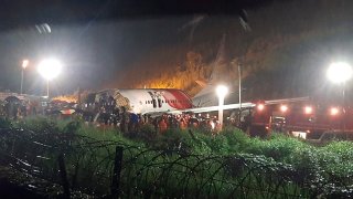 An Air India Express flight skidded off a runway while landing at the airport in Kozhikode, Kerala, India, Friday, Aug. 7, 2020.