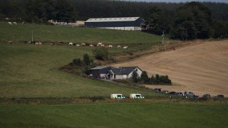 Emergency services in Stonehaven, Scotland, near the scene where a train derailed. Police and paramedics were responding Wednesday to a train derailment in northeast Scotland, where smoke could be seen rising from the site. Officials said there were reports of serious injuries. The hilly area was hit by storms and flash flooding overnight.