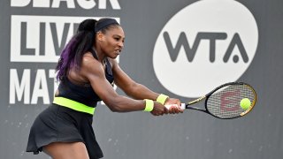 Serena Williams returns a shot to her sister Venus Williams during the WTA tennis tournament