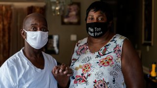 Mary and Barrett Duplessis pose for a portrait in their home in New Orleans