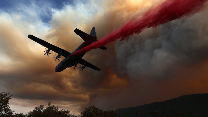An airplane drops retardant ahead of the LNU Lightning Complex fire.