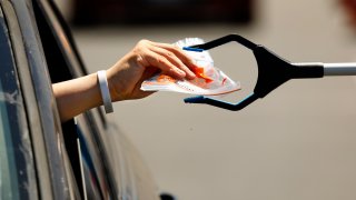 File Image: A test kit is passed through the car window at the Anaheim Convention Center.