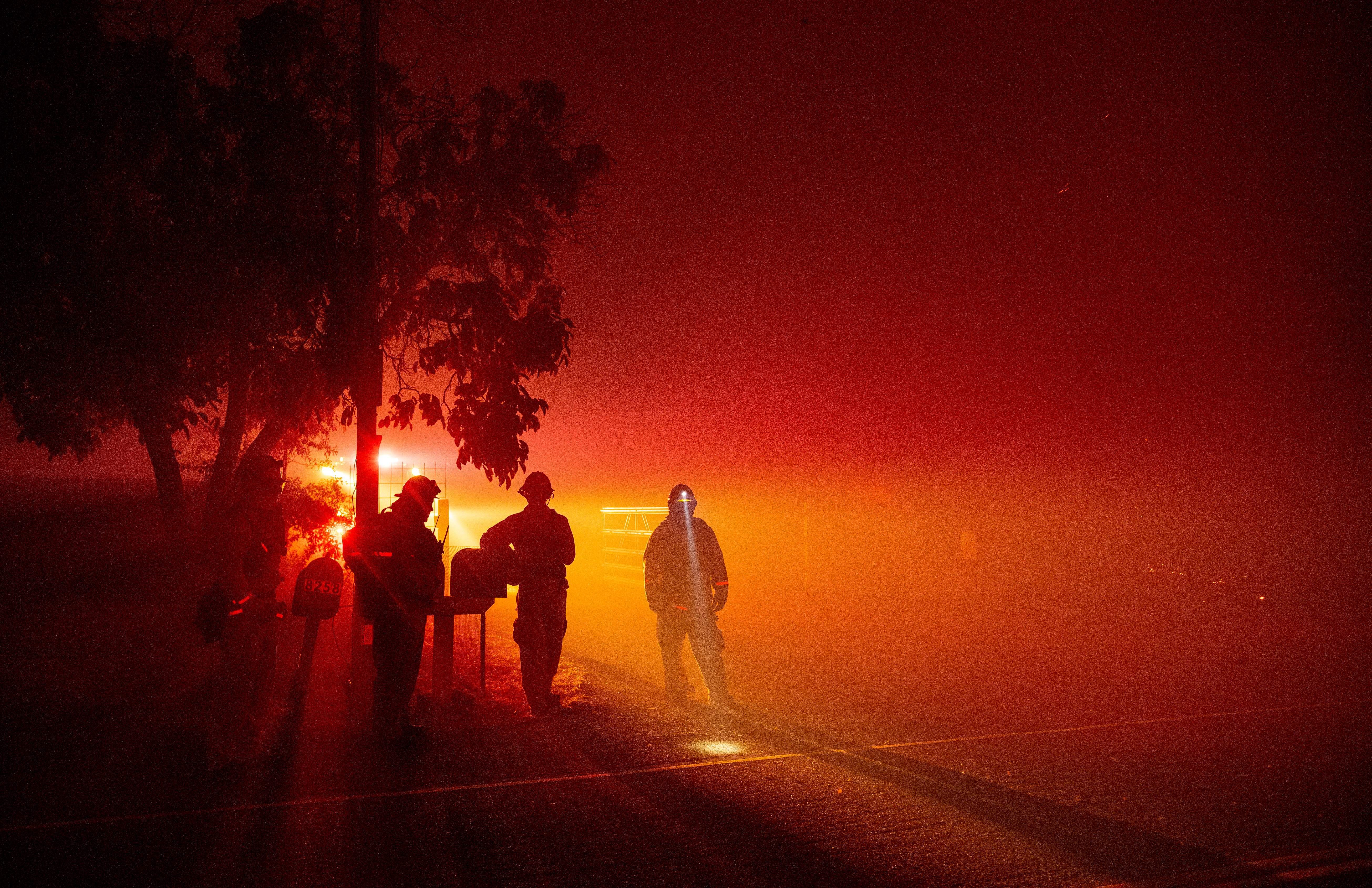 TOPSHOT – Firefighters monitor flames as they approach a residence in the valley area of Vacaville, northern California during the LNU Lightning Complex fire on August 19, 2020. – As of the late hours of August 18, the Hennessey fire has merged with at least 7 fires and is now called the LNU Lightning Complex fires. Dozens of fires are burning out of control throughout Northern California as fire resources are spread thin. (Photo by JOSH EDELSON / AFP) (Photo by JOSH EDELSON/AFP via Getty Images)