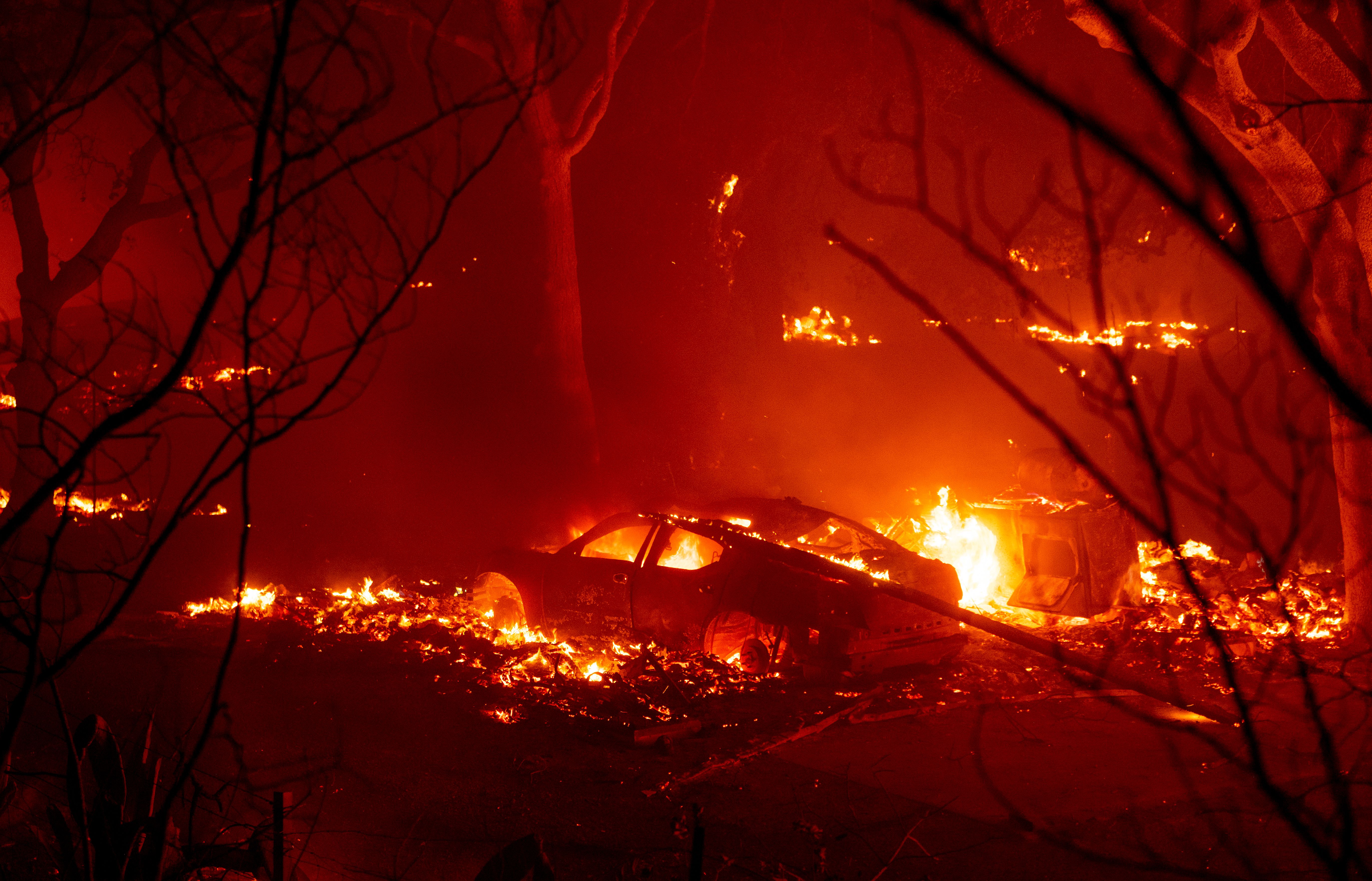 A car burns at a residence in the valley area of Vacaville, northern California during the LNU Lightning Complex fire on August 19, 2020. – As of the late hours of August 18, the Hennessey fire has merged with at least 7 fires and is now called the LNU Lightning Complex fires. Dozens of fires are burning out of control throughout Northern California as fire resources are spread thin. (Photo by JOSH EDELSON / AFP) (Photo by JOSH EDELSON/AFP via Getty Images)
