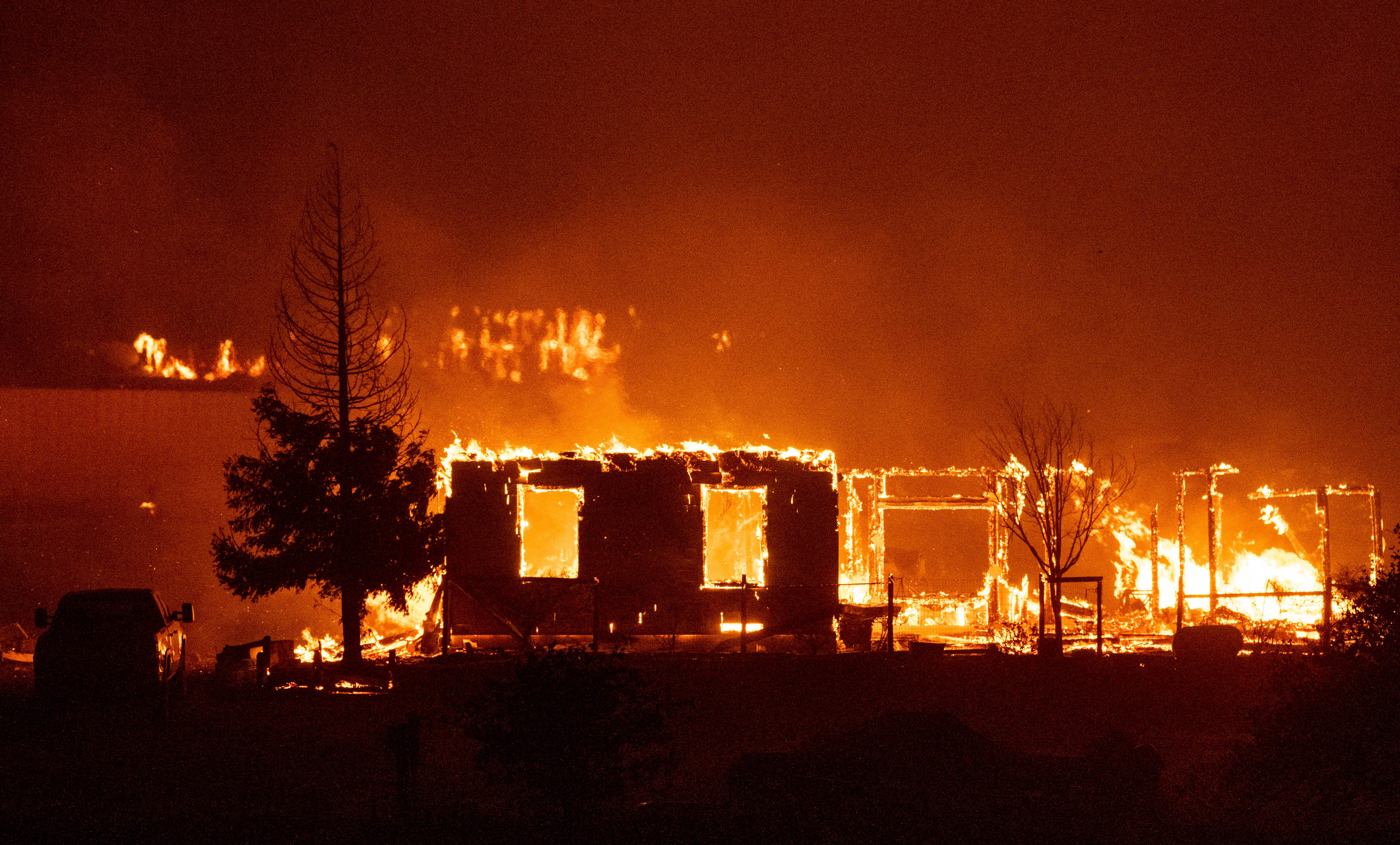 Homes are engulfed in flames in Vacaville, California during the LNU Lightning Complex fire on August 19, 2020. – As of the late hours of August 18,2020 the Hennessey fire has merged with at least 7 fires and is now called the LNU Lightning Complex fires. Dozens of fires are burning out of control throughout Northern California as fire resources are spread thin. (Photo by JOSH EDELSON / AFP) (Photo by JOSH EDELSON/AFP via Getty Images)