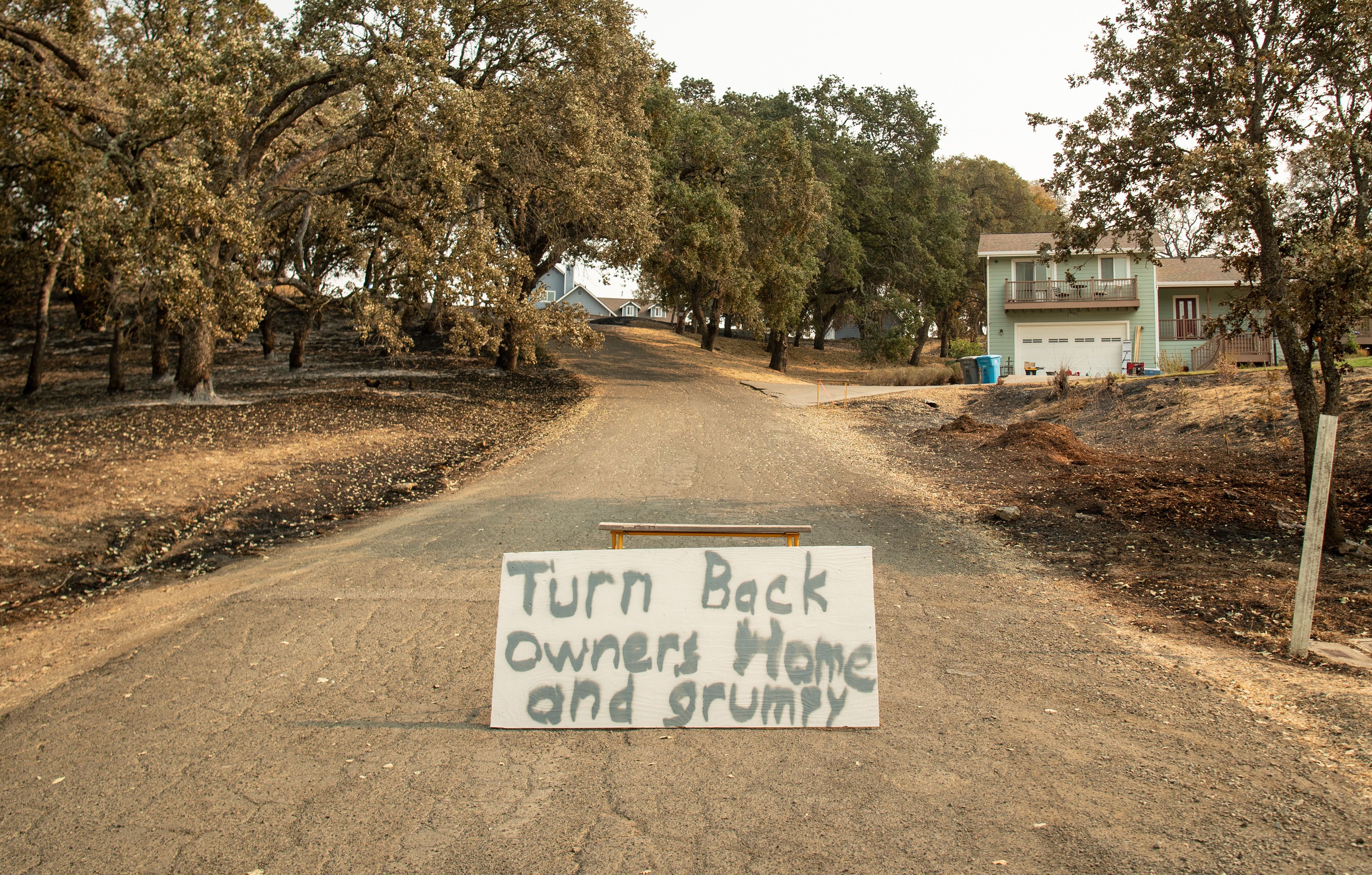 A sign asking for privacy is posted in the middle of a street during the LNU Lightning Complex fire in Bucktown, California on August 24, 2020. – Thousands of firefighters made small progress on August 24 as they battled to contain historic wildfires in California, with potentially dangerous lighting storms proving milder than expected and temperatures easing.<br />
Governor Gavin Newsom said some 625 fires were burning throughout the state and had scorched more than 1.2 million acres — nearly the size of the Grand Canyon. (Photo by JOSH EDELSON / AFP) (Photo by JOSH EDELSON/AFP via Getty Images)