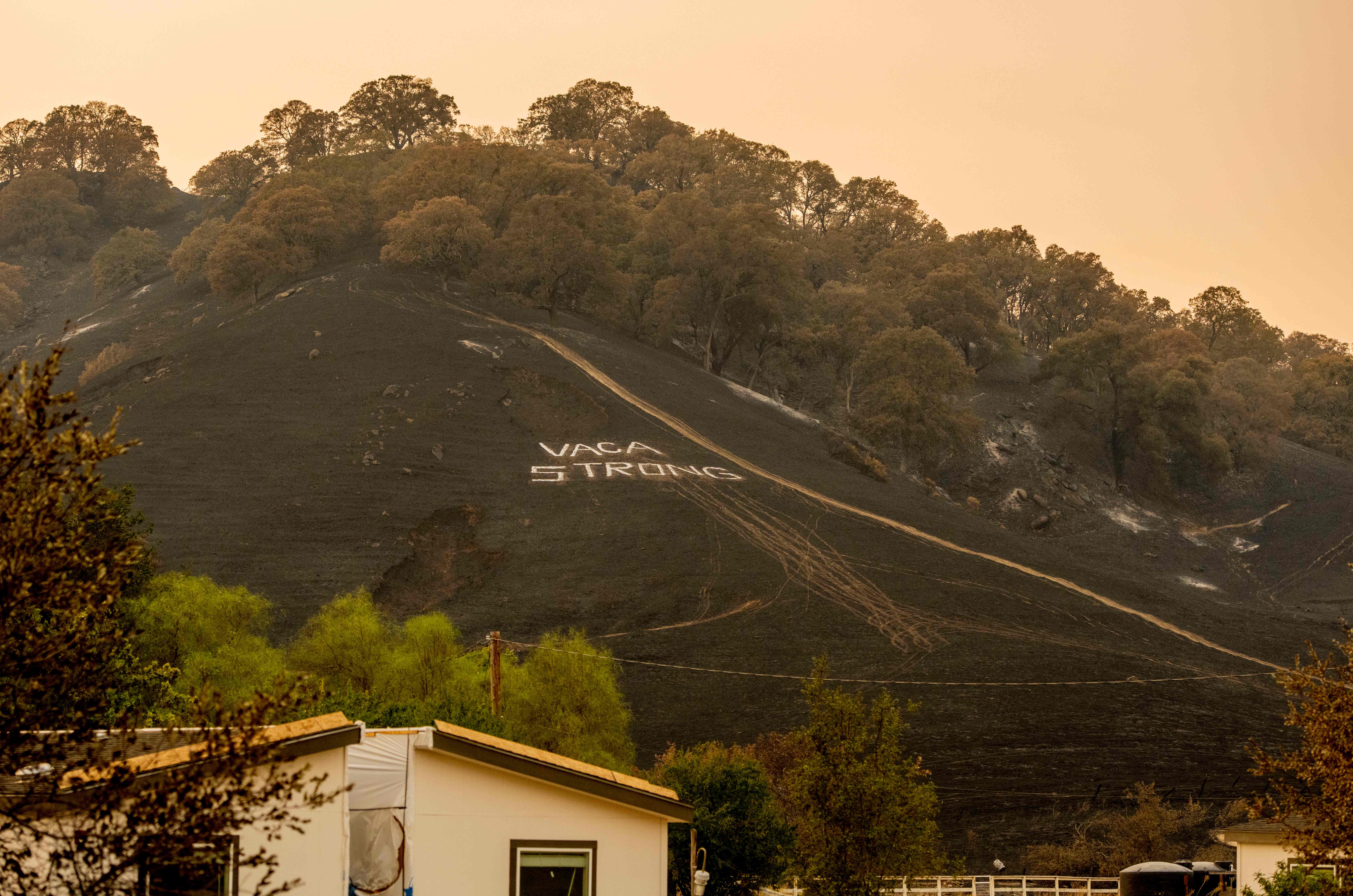 A ‘Vaca Strong’ message is painted onto a burned hillside during the LNU Lightning Complex fire in Vacaville, California on August 24, 2020. – Thousands of firefighters made small progress on August 24 as they battled to contain historic wildfires in California, with potentially dangerous lighting storms proving milder than expected and temperatures easing.<br />
Governor Gavin Newsom said some 625 fires were burning throughout the state and had scorched more than 1.2 million acres — nearly the size of the Grand Canyon. (Photo by JOSH EDELSON / AFP) (Photo by JOSH EDELSON/AFP via Getty Images)