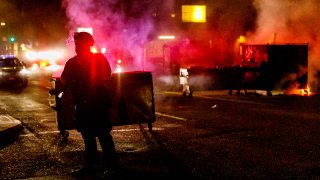 About two hundred persons protesting police brutality spray graffiti and start fires at the Portland Police Union building, in Portland, Oregon, United States on August 28, 2020, the 93rd day of consecutive protests.