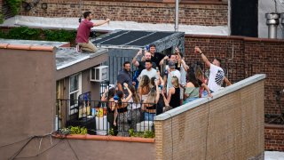 People party on a rooftop in Kips Bay, New York.