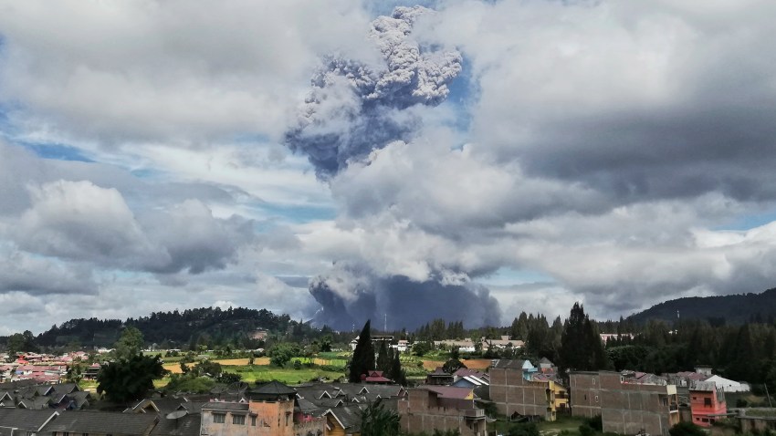 Mount Sinabung spews volcanic materials into the air as it erupts, in Karo, North Sumatra, Indonesia, Monday, Aug. 10, 2020.