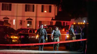 Police officials work at a scene