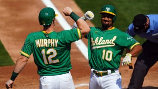 Marcus Semien of the Oakland Athletics is greeted by teammate Sean Murphy.