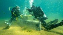 Divers recover trash from the bottom of Lake Tahoe.