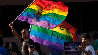 Ignacio Rios, left, of Santa Ana marches with fellow protesters against the detention of transgender women in Santa Ana on Thursday, May 4, 2017.