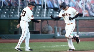 SAN FRANCISCO, CALIFORNIA – SEPTEMBER 25: Wilmer Flores #41 of the San Francisco Giants is congratulated by third base coach Ron Wotus after he hit a home run in the fourth inning against the San Diego Padres of game one of their double header at Oracle Park on September 25, 2020 in San Francisco, California. (Photo by Ezra Shaw/Getty Images)
