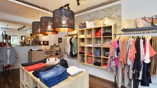 Interior shot of a fashion boutique. Selling women's clothes and accessories. Small business.