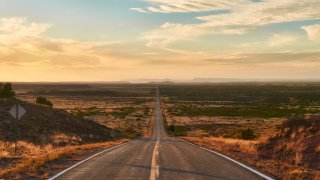 A lonely highway stretches beyond the horizon north of Tucumcari, New Mexico