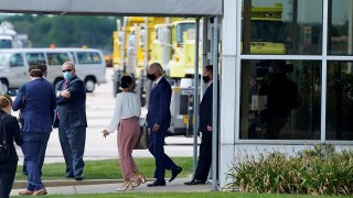 In this image taken from a motorcade, Democratic presidential candidate former Vice President Joe Biden exits a building after meeting with relatives of Jacob Blake at General Mitchell International Airport, Sept. 3, 2020, in Milwaukee.