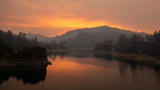 Smoke from the LNU Lightning Complex fire is reflected on Lake Berryessa.